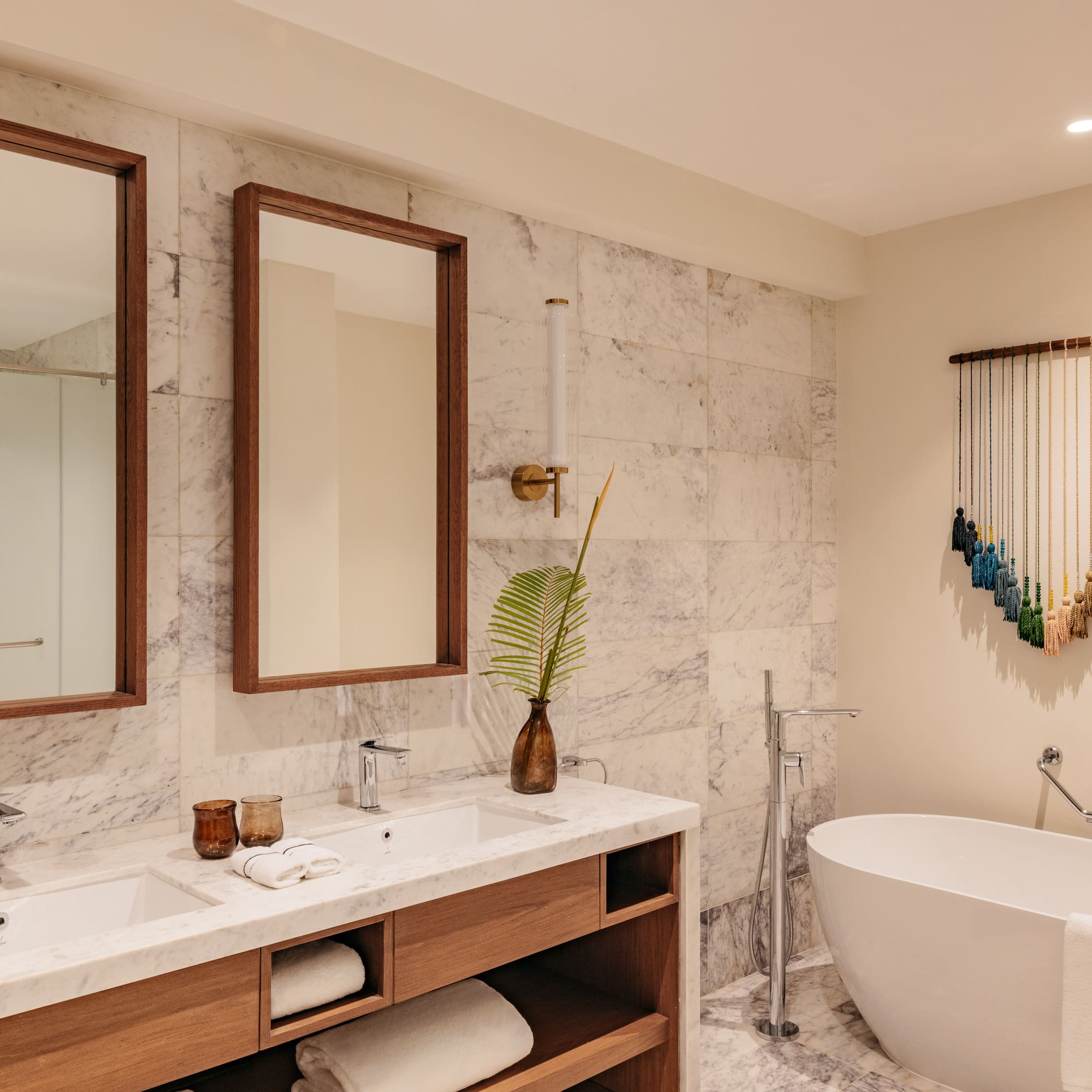 a bathroom with a tub and mirrors