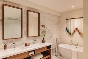 a bathroom with a tub and mirrors