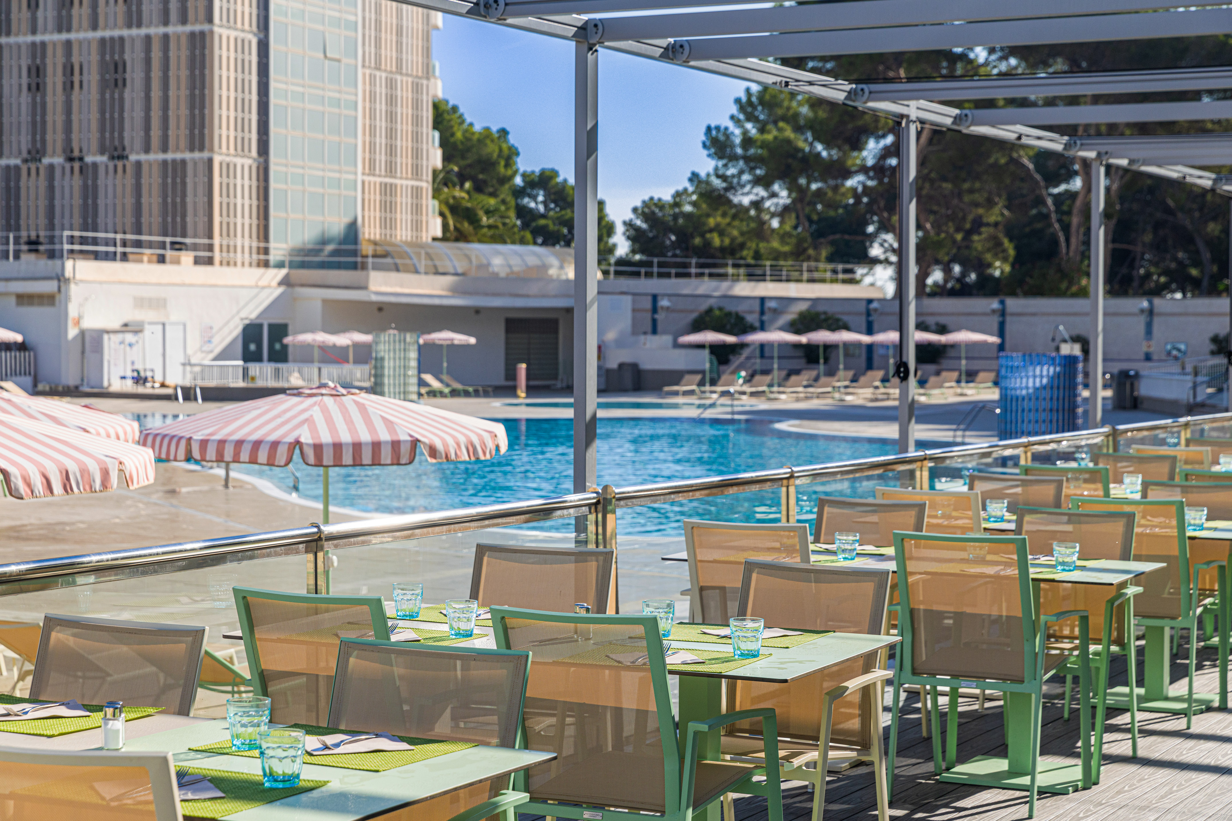a pool with tables and chairs