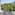 Apartment balcony with white chair, city view, green trees, and European architecture.