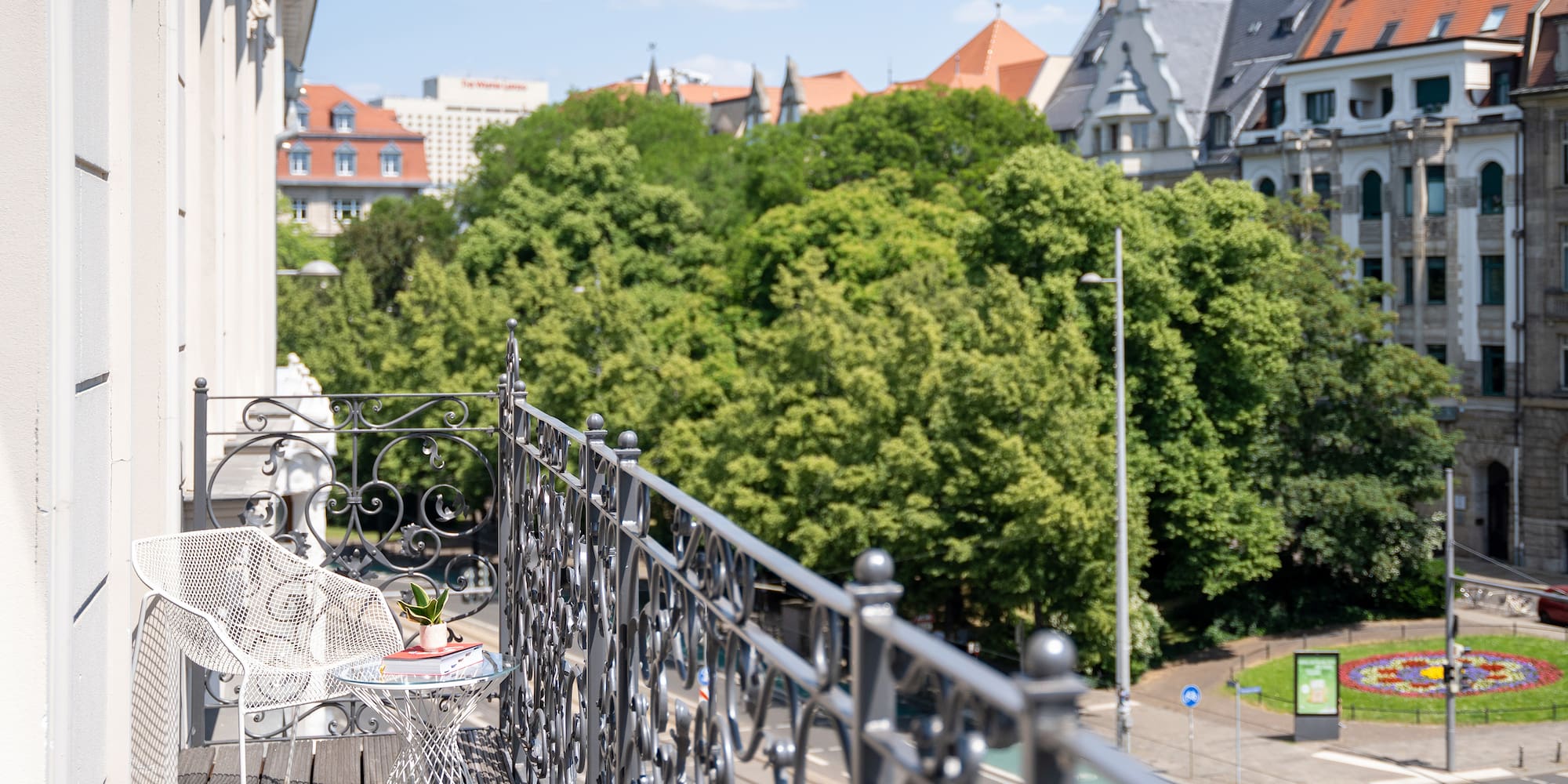 a balcony with a table and chairs on it