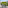 Apartment balcony with white chair, city view, green trees, and European architecture.