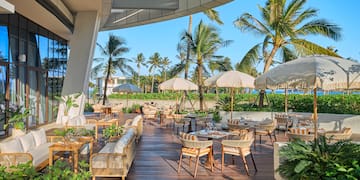 a patio with chairs and umbrellas