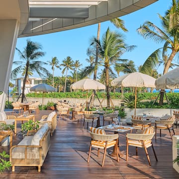 a patio with chairs and umbrellas