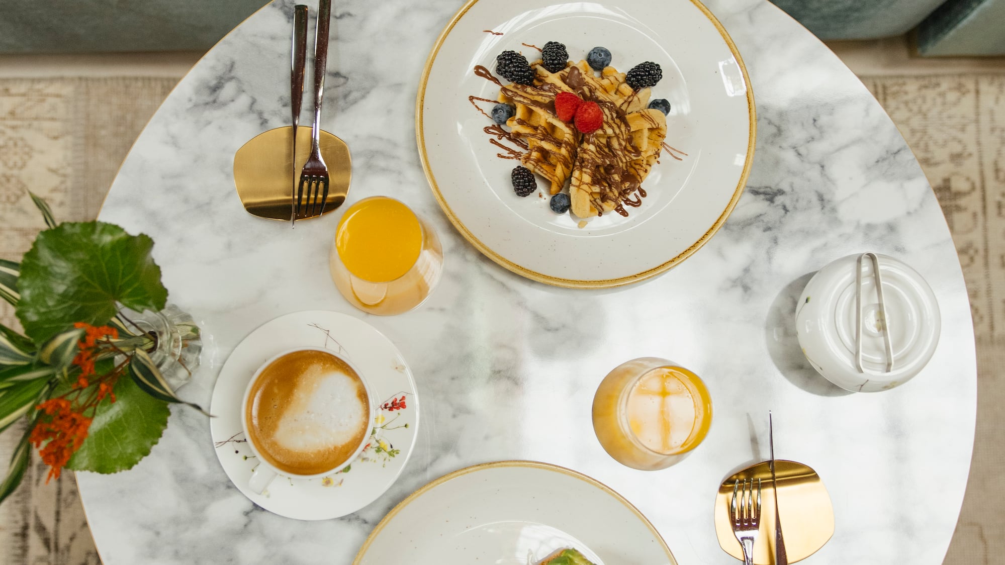 a table with plates of food and drinks