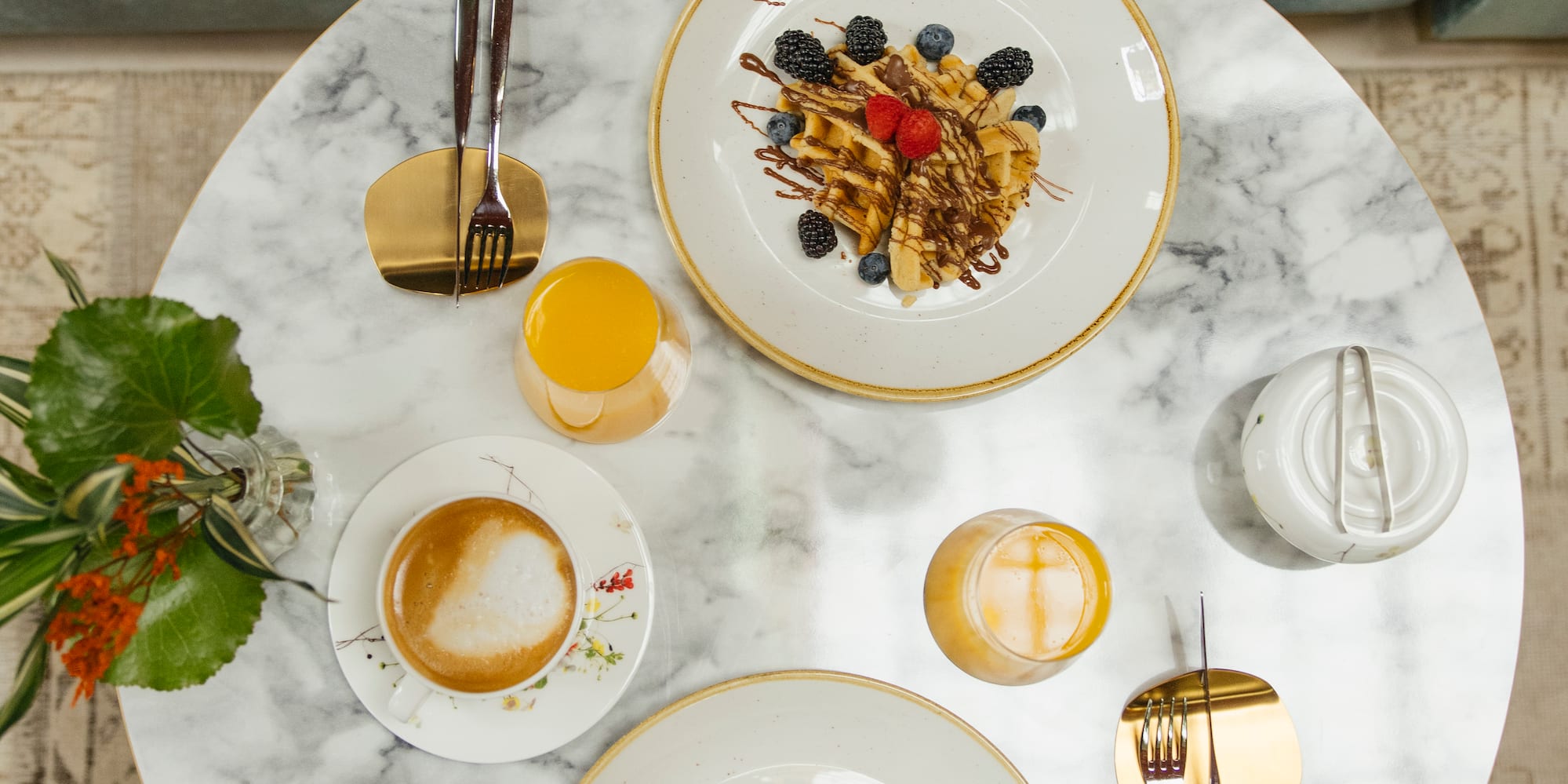 a table with plates of food and drinks