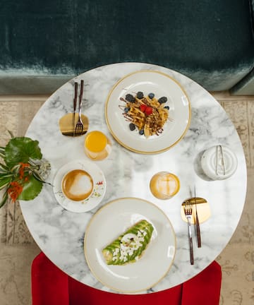 a table with plates of food and drinks