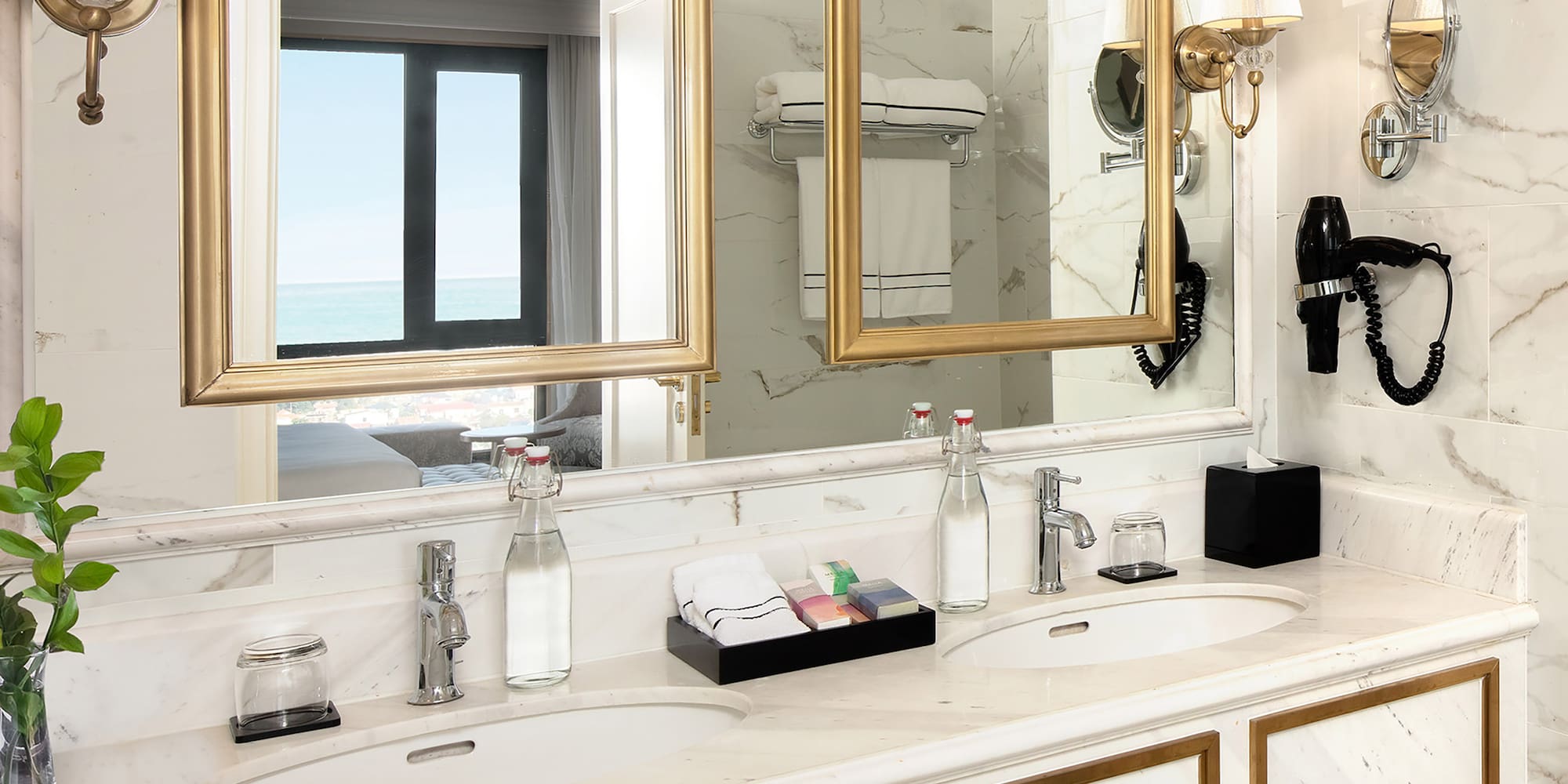 a bathroom with a large mirror and two sinks