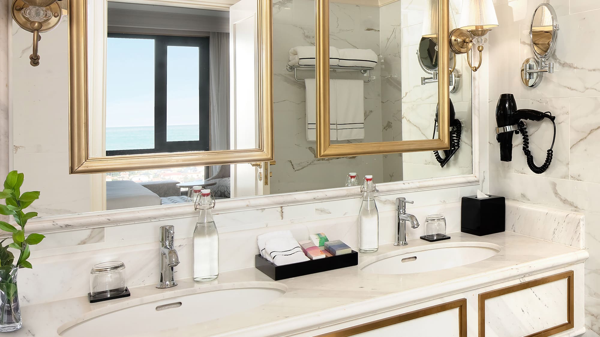 a bathroom with a large mirror and two sinks