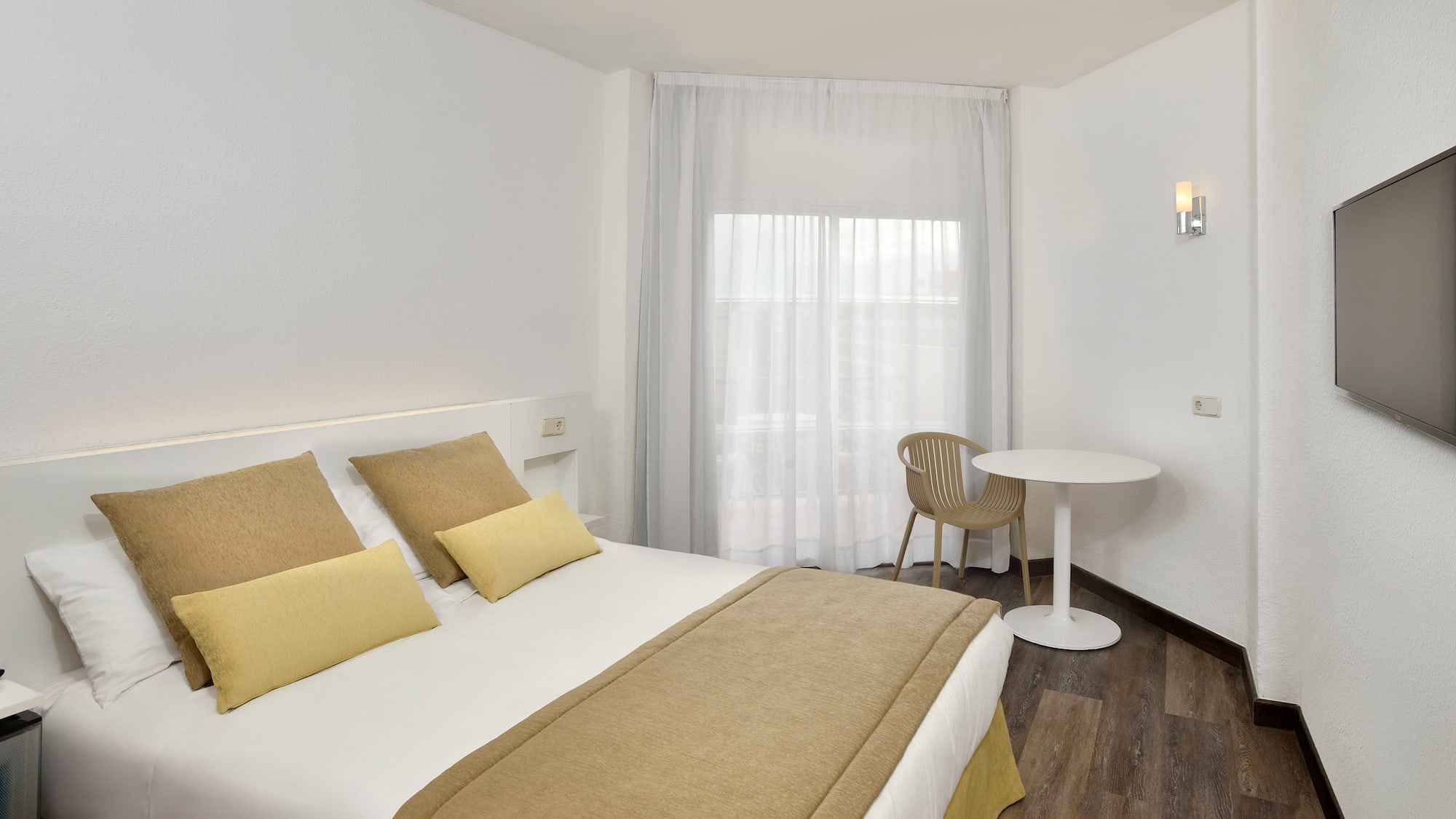 a bed with a table and chairs in a room
