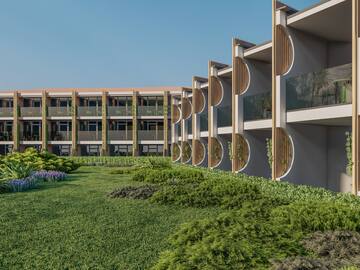a building with a lawn and plants
