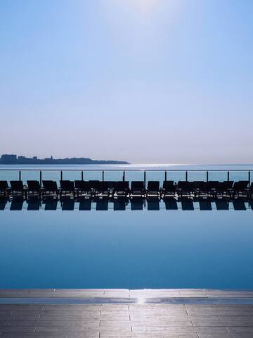 a pool with chairs and a railing