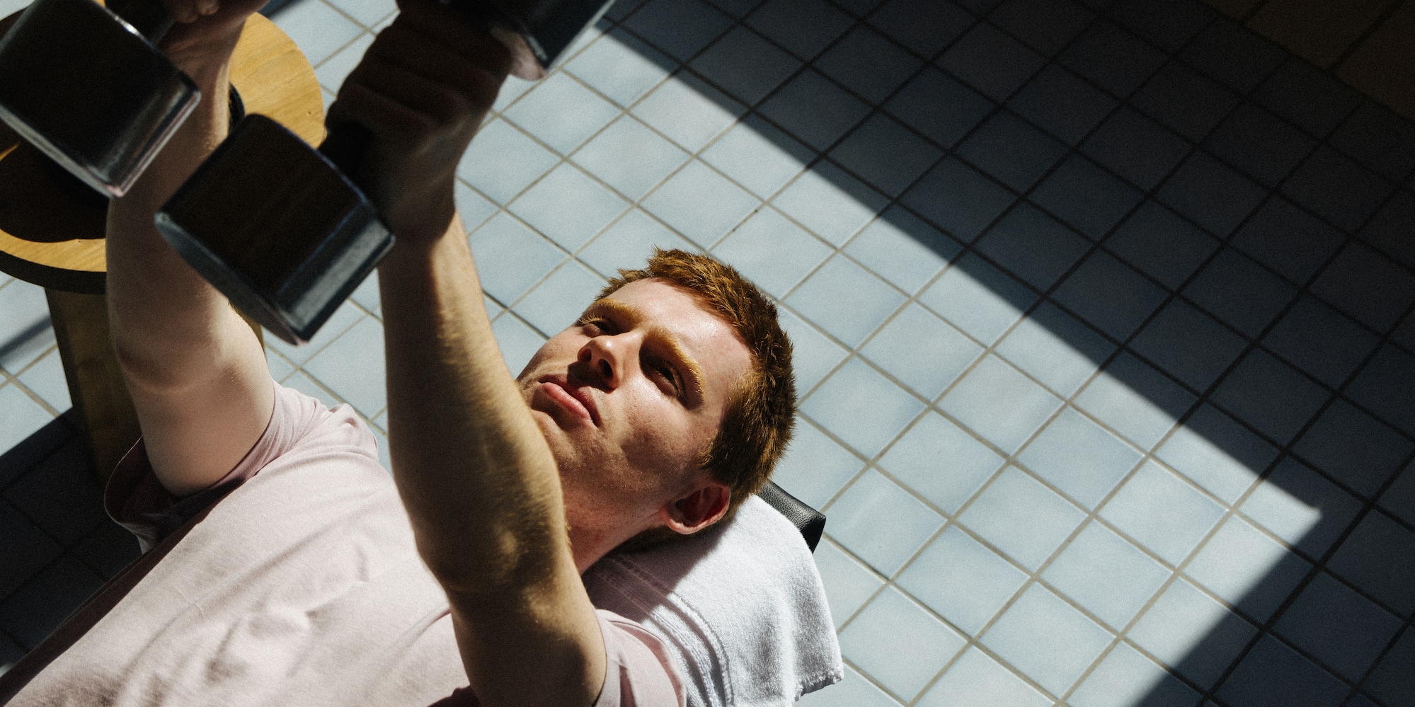 a man lifting weights on a bench