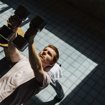 a man lifting weights on a bench