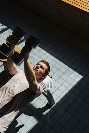 a man lifting weights on a bench