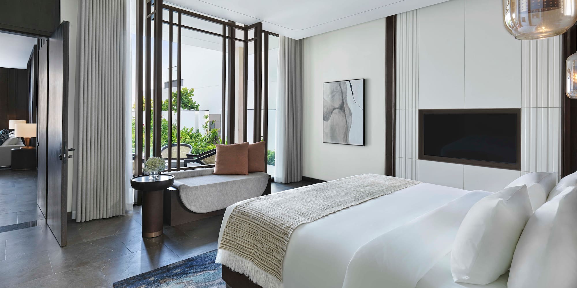 a bedroom with a bed and a television