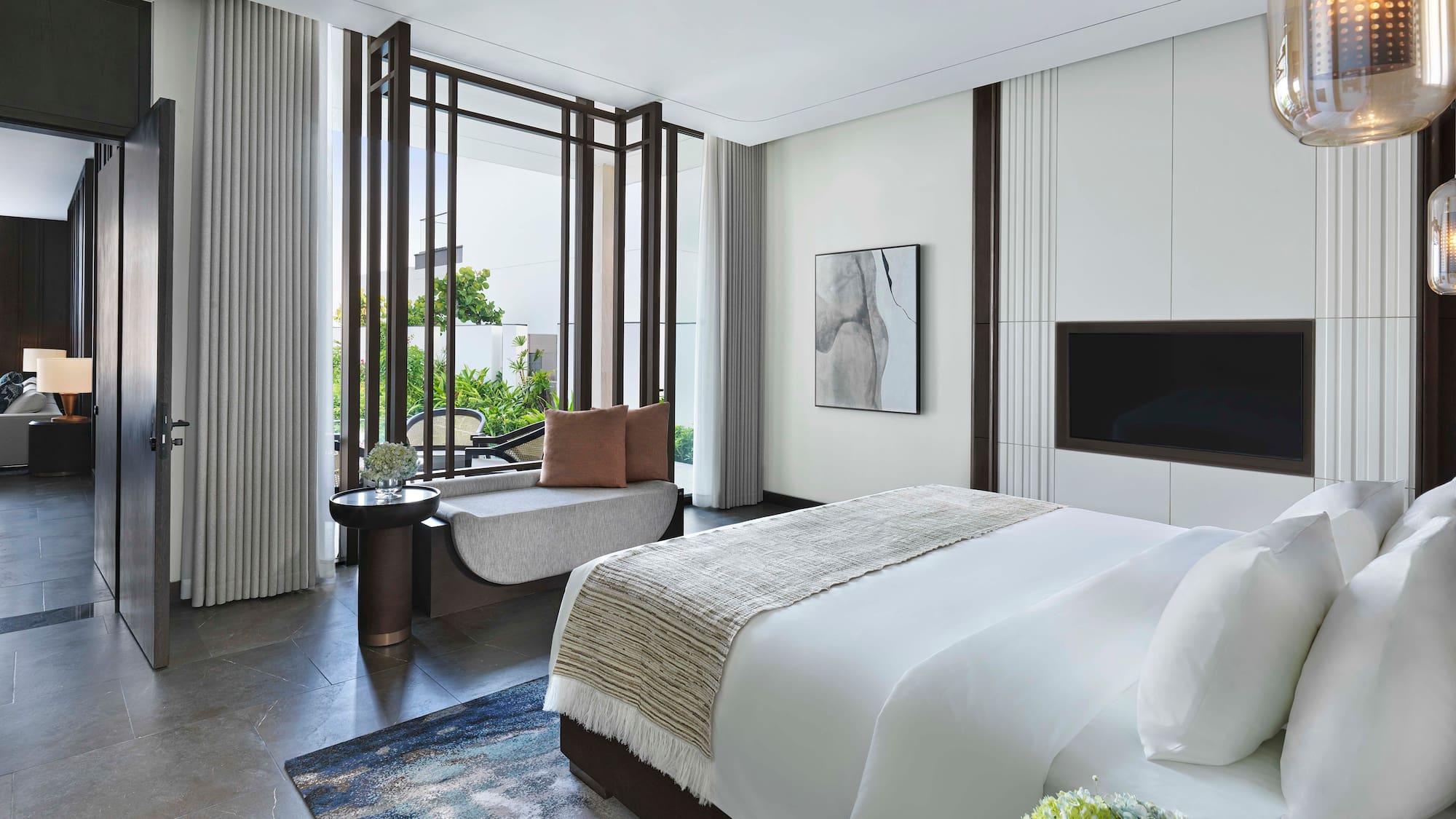 a bedroom with a bed and a television