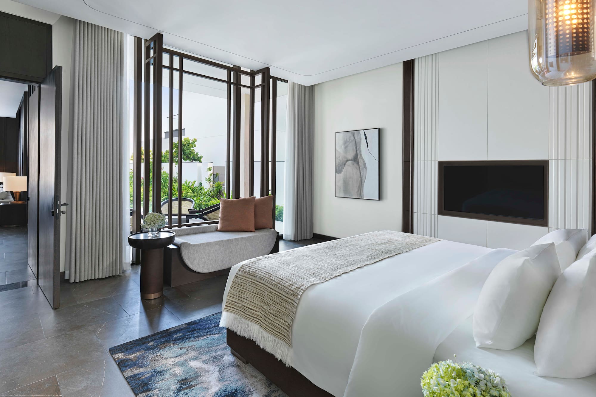 a bedroom with a bed and a television