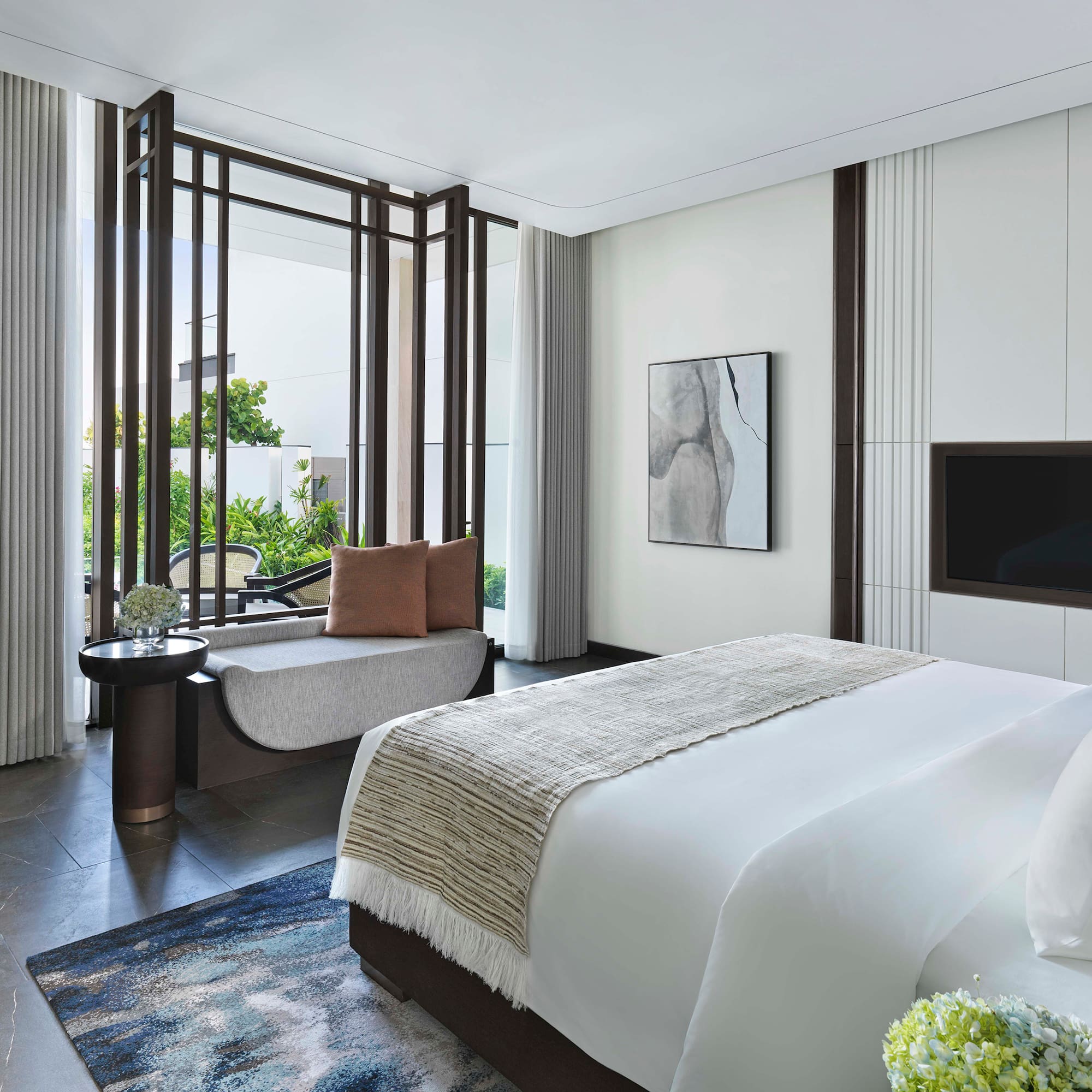 a bedroom with a bed and a television