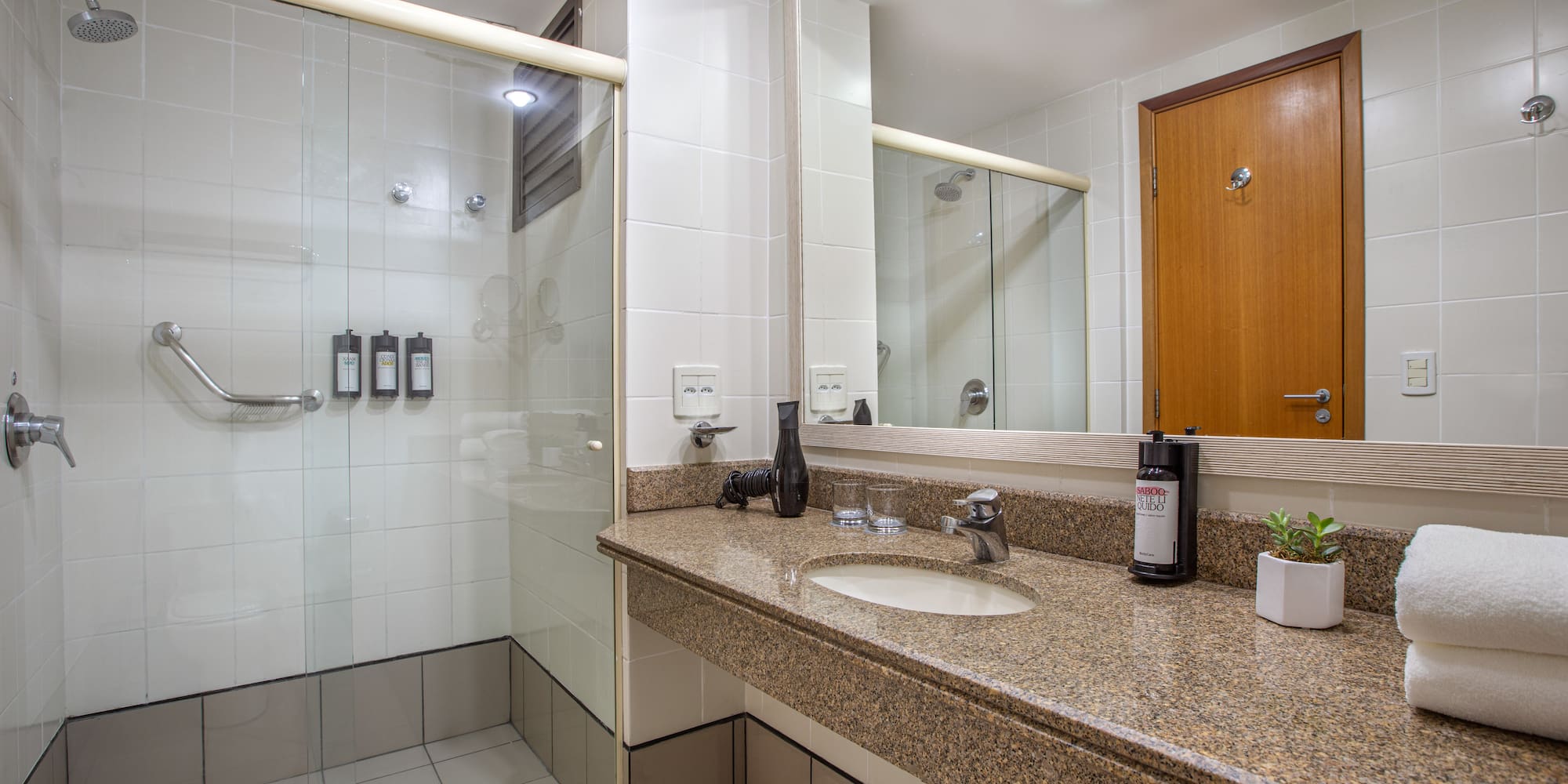 a bathroom with a shower and a sink