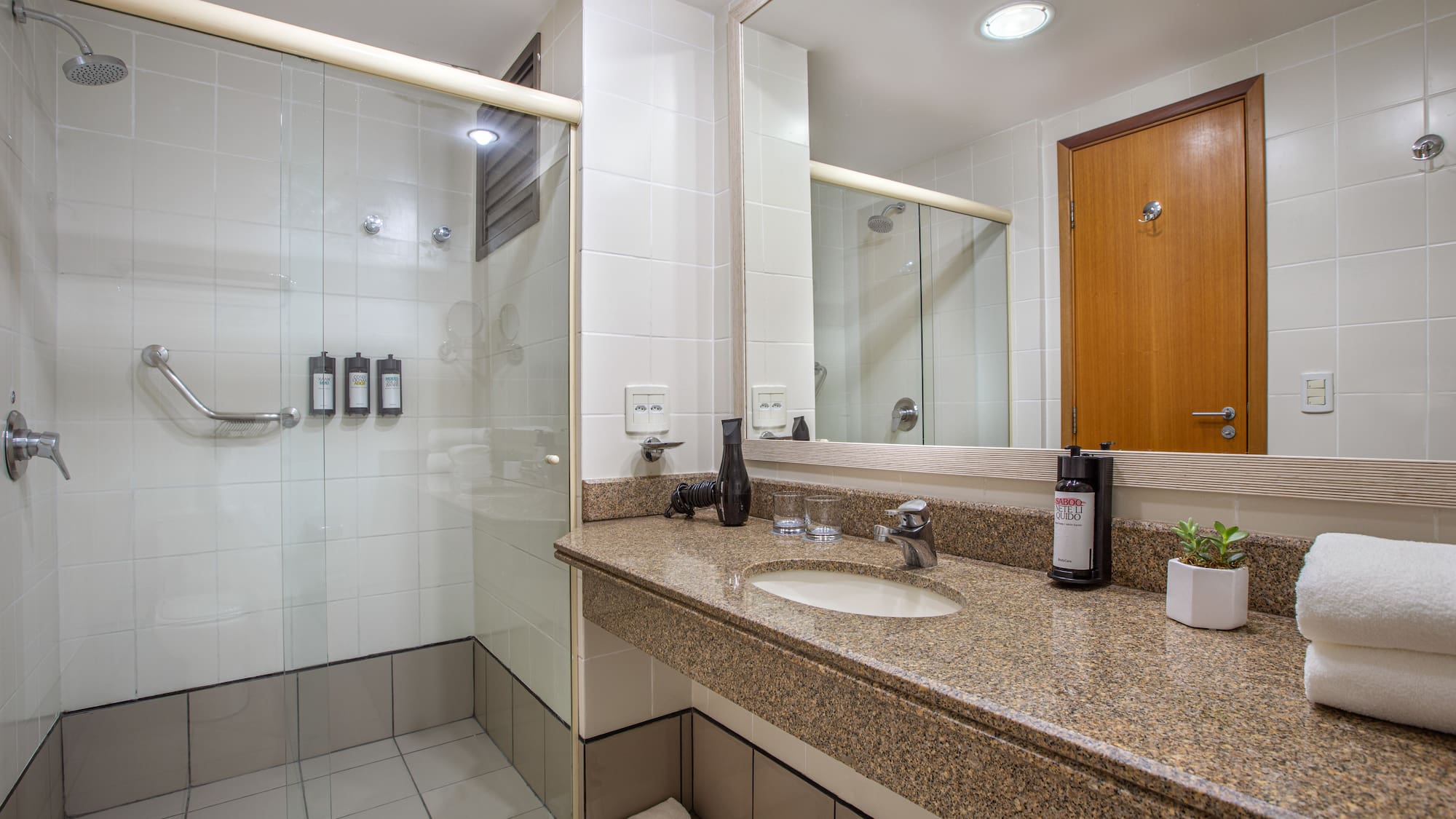 a bathroom with a shower and a sink