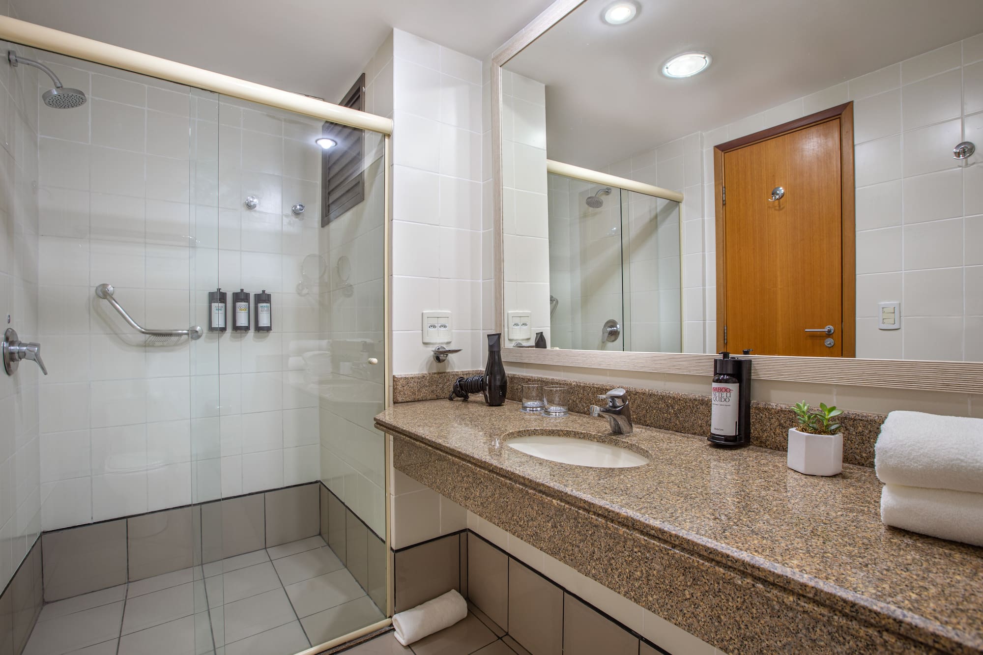 a bathroom with a shower and a sink