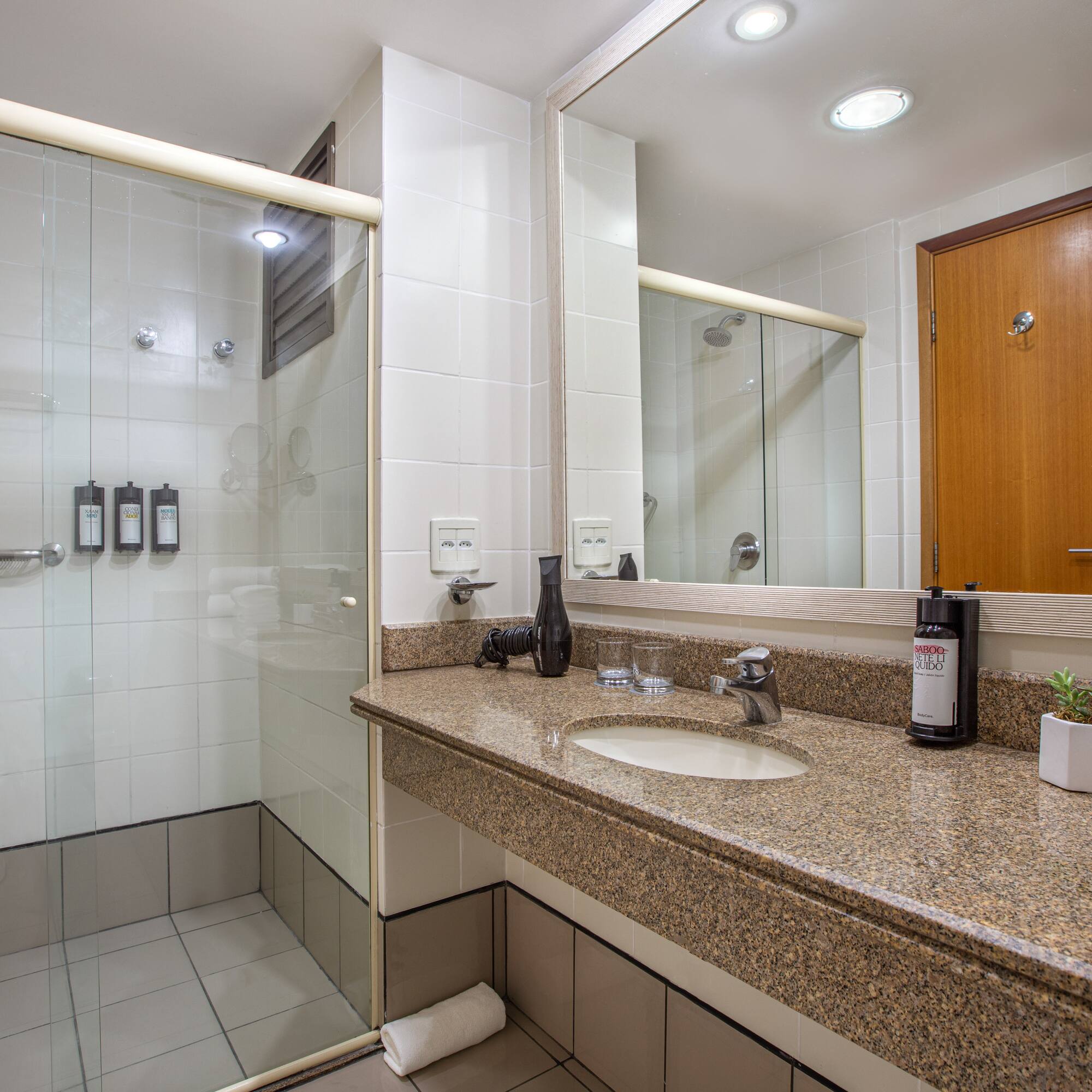 a bathroom with a shower and a sink