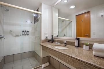 a bathroom with a shower and a sink