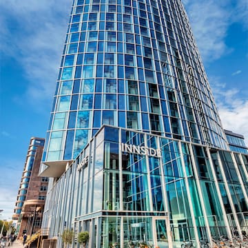 a tall glass building with a blue sky