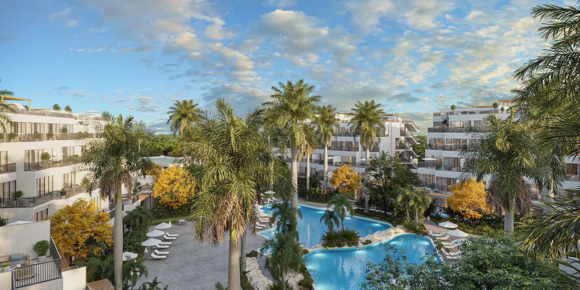 Tropical resort with large swimming pool, palm trees, and modern hotel buildings.