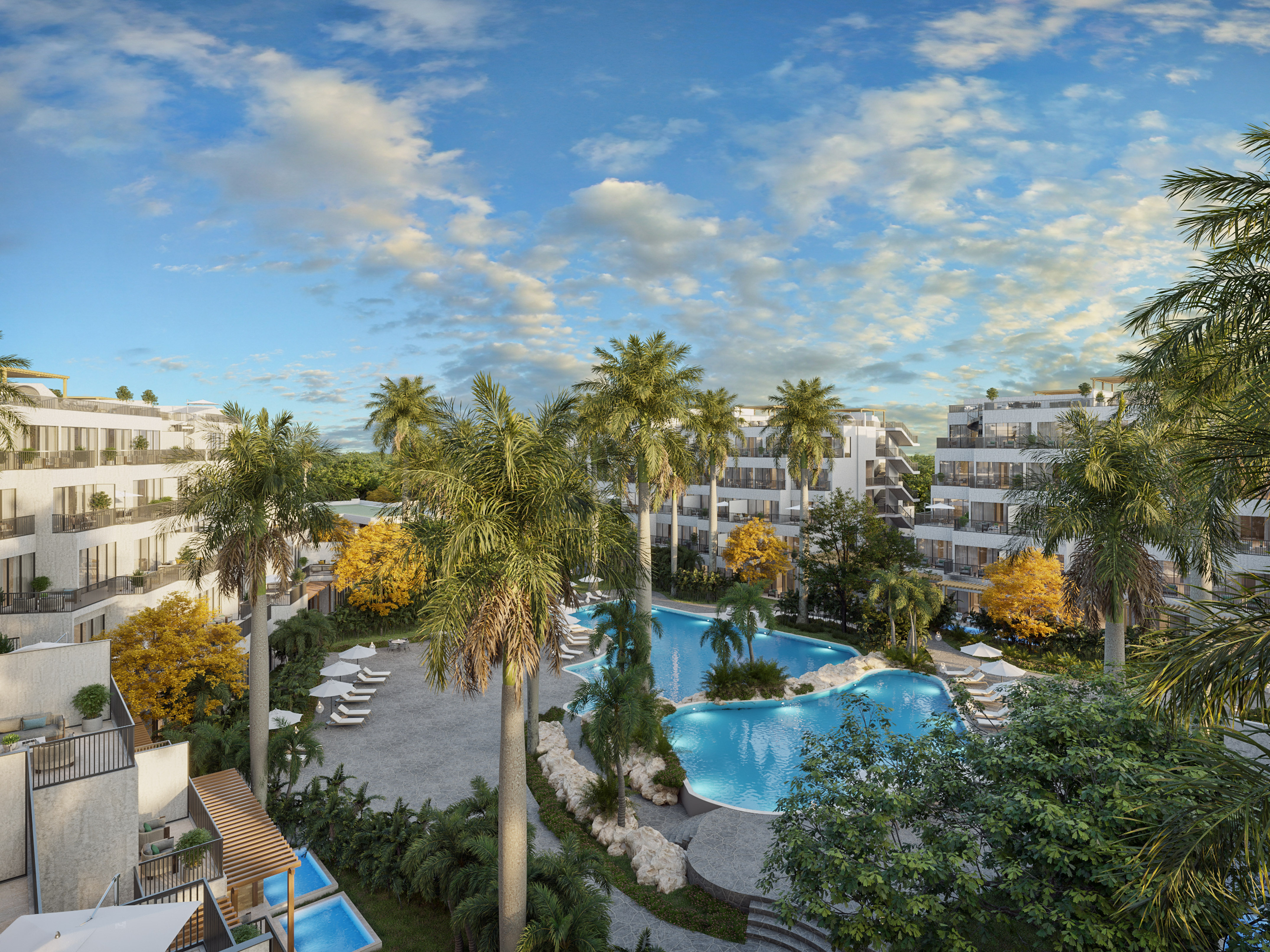 Tropical resort with large swimming pool, palm trees, and modern hotel buildings.