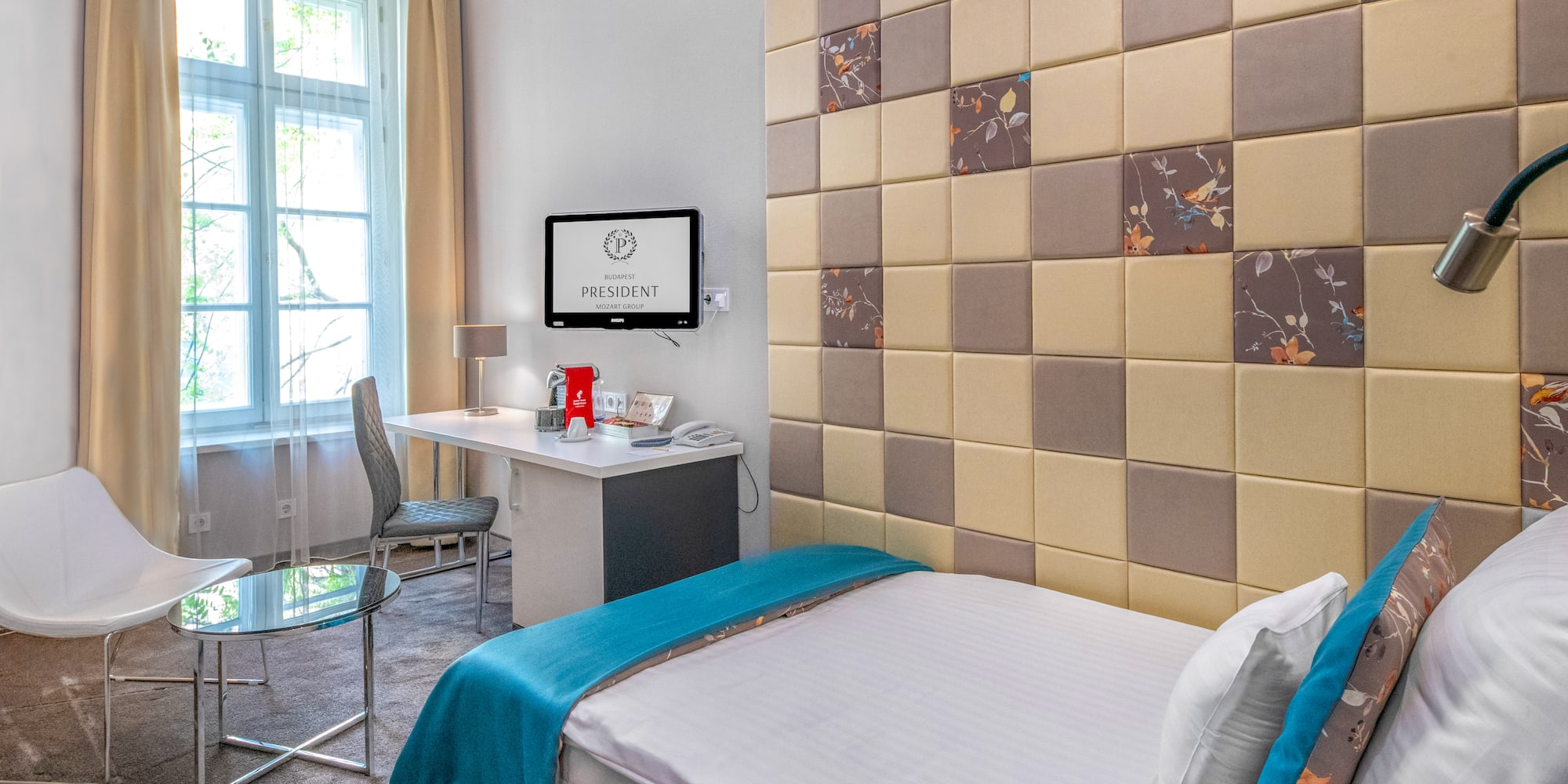 a room with a bed and a desk and chair