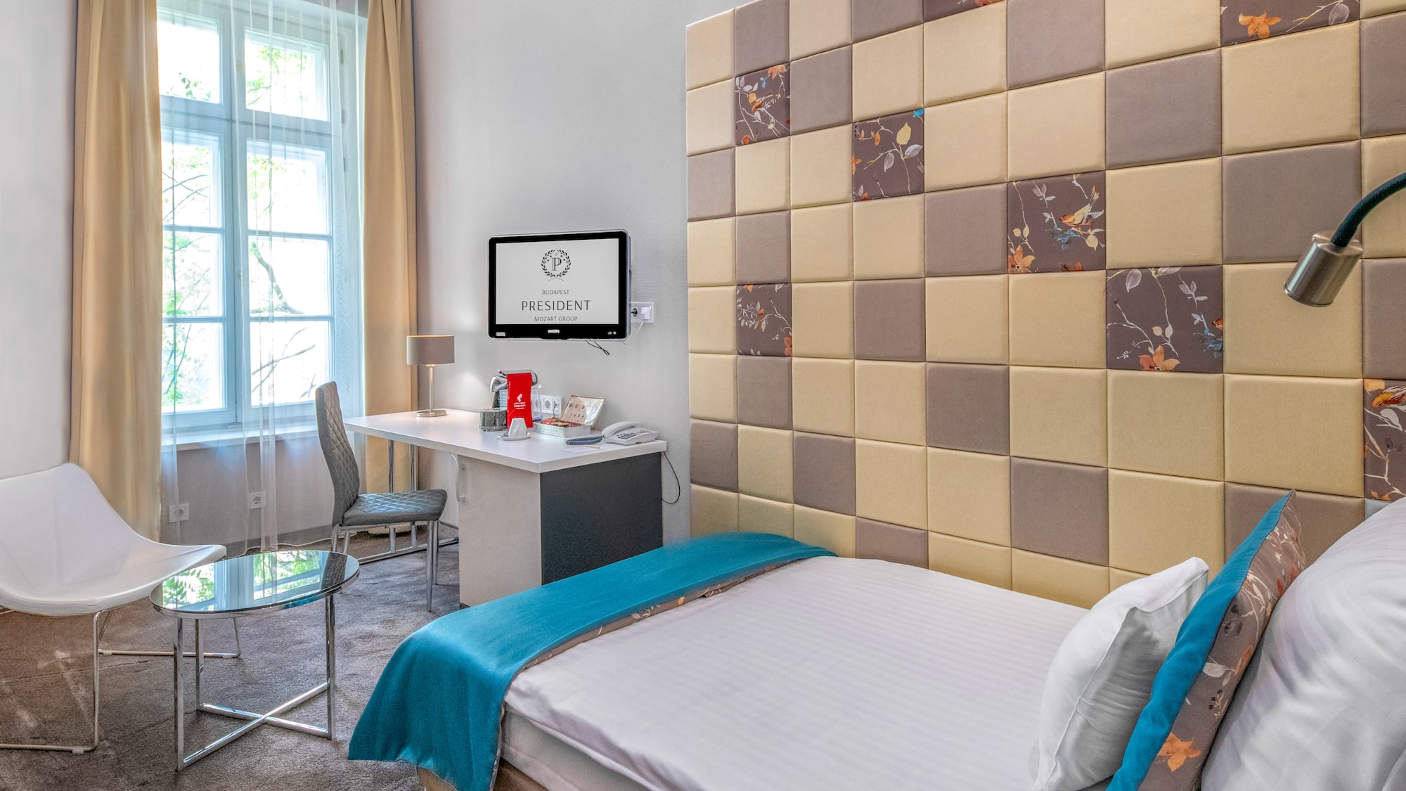 a room with a bed and a desk and chair