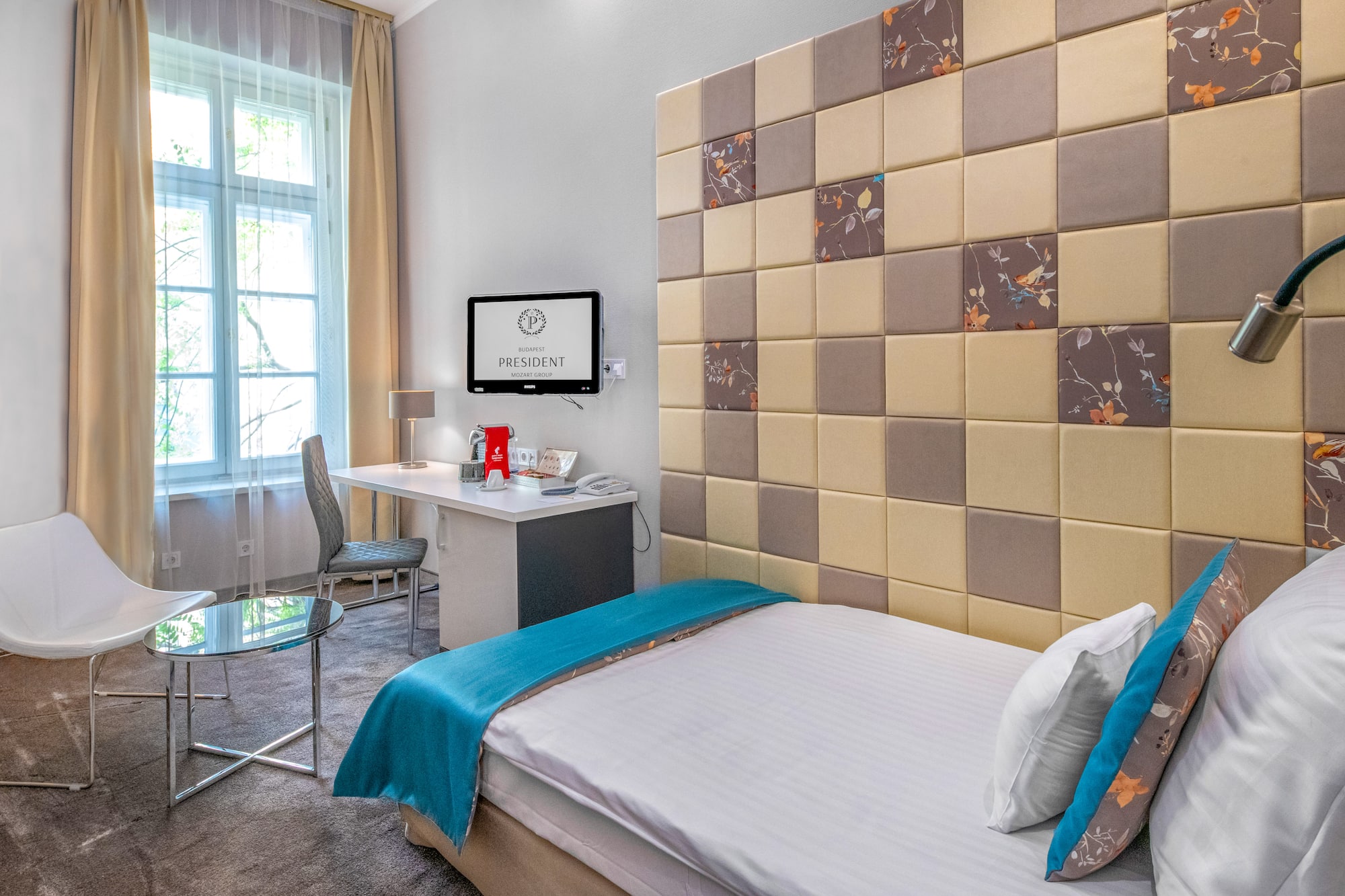 a room with a bed and a desk and chair