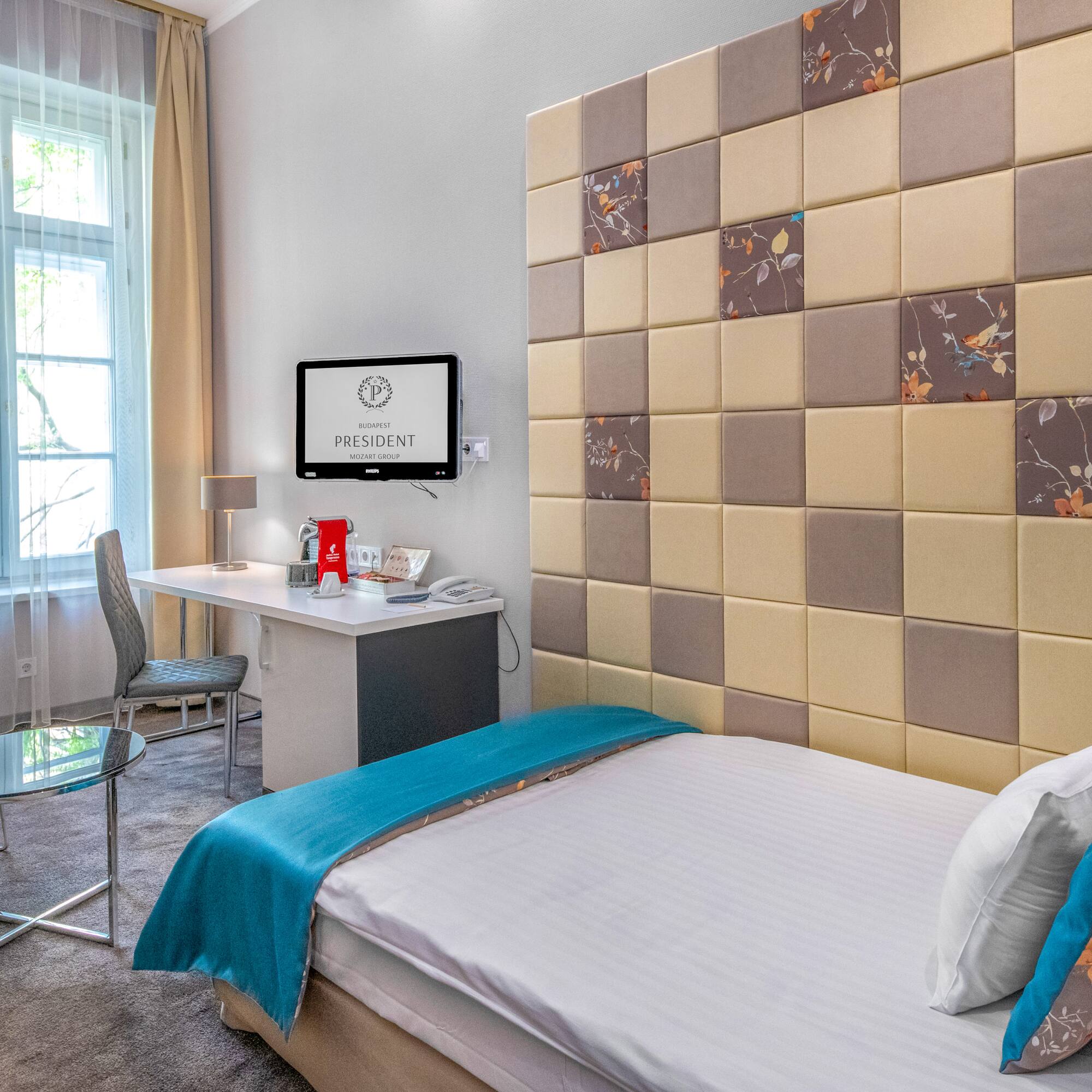 a room with a bed and a desk and chair