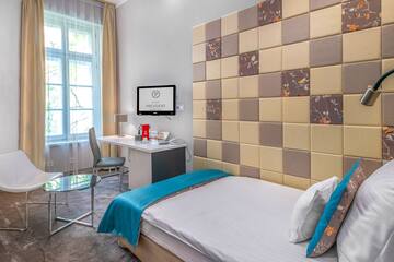 a room with a bed and a desk and chair