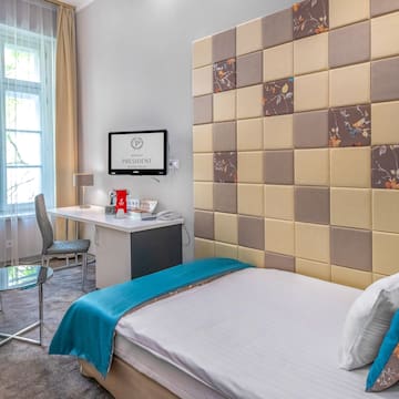 a room with a bed and a desk and chair