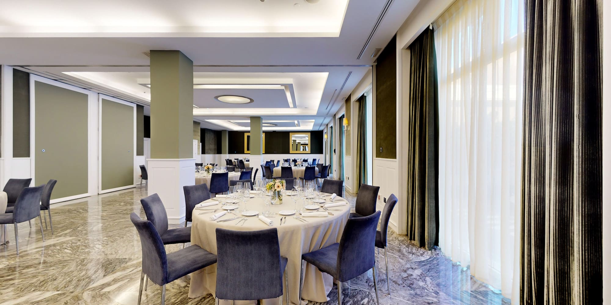 a room with a round table and chairs