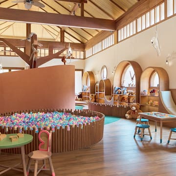 a room with a play area and a play slide