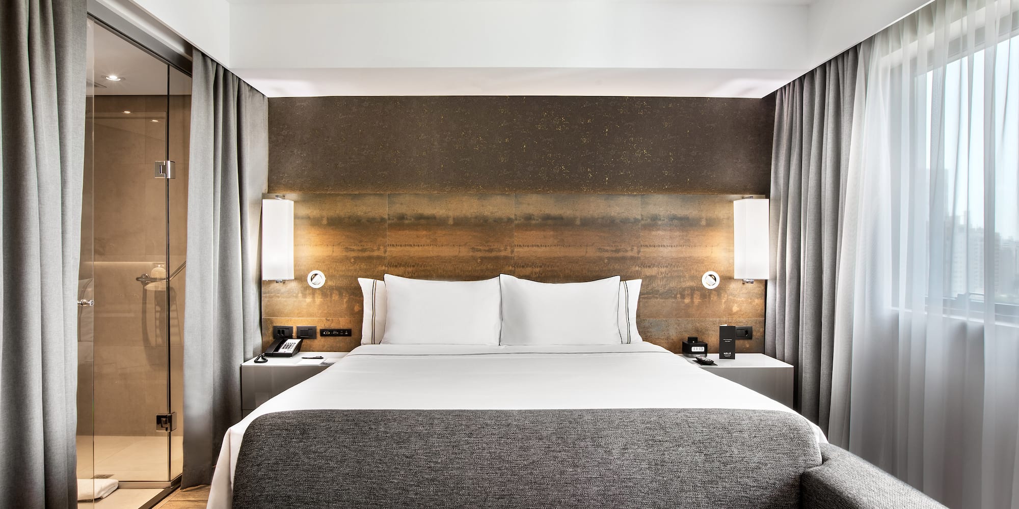 a bed with a couch and a lamp