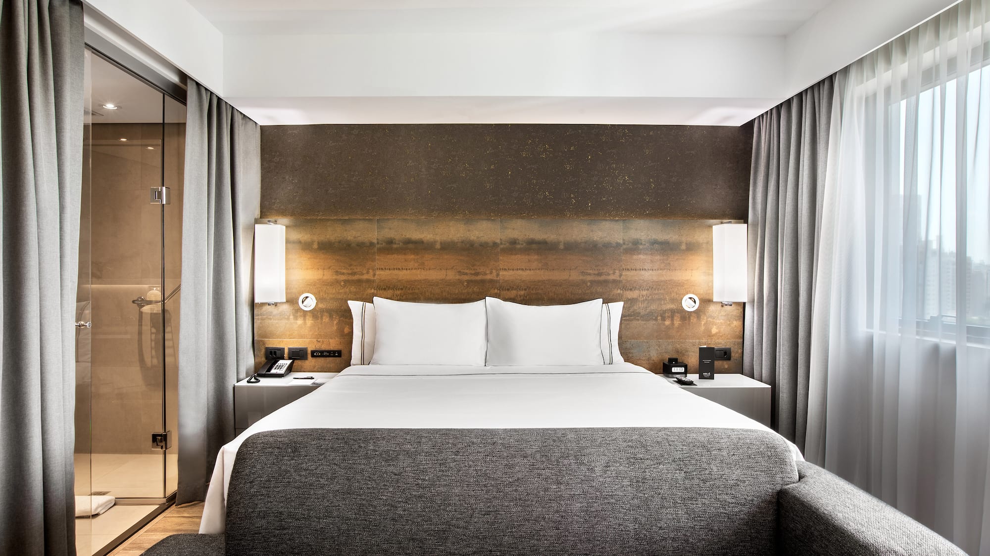 a bed with a couch and a lamp