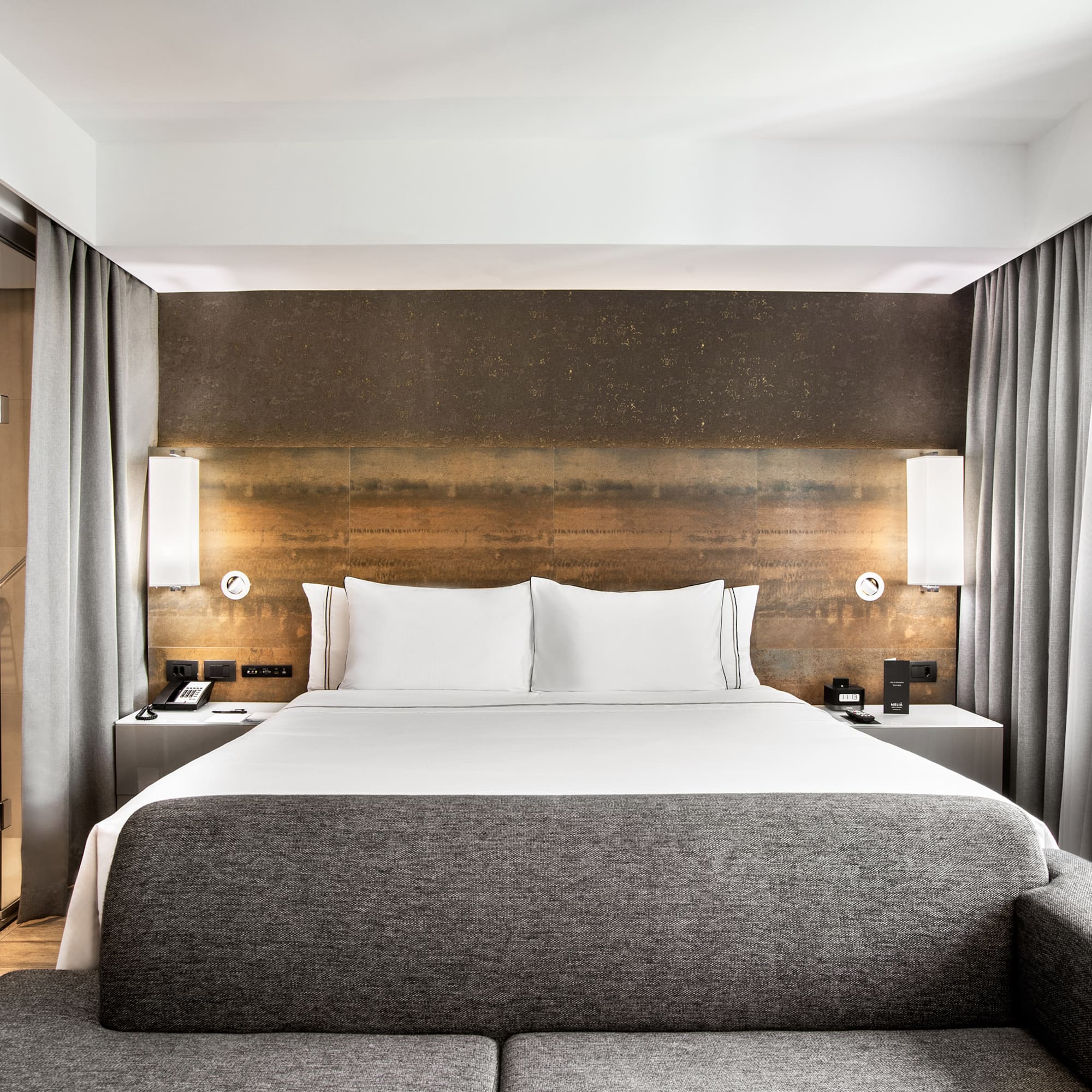 a bed with a couch and a lamp