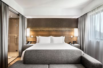 a bed with a couch and a lamp