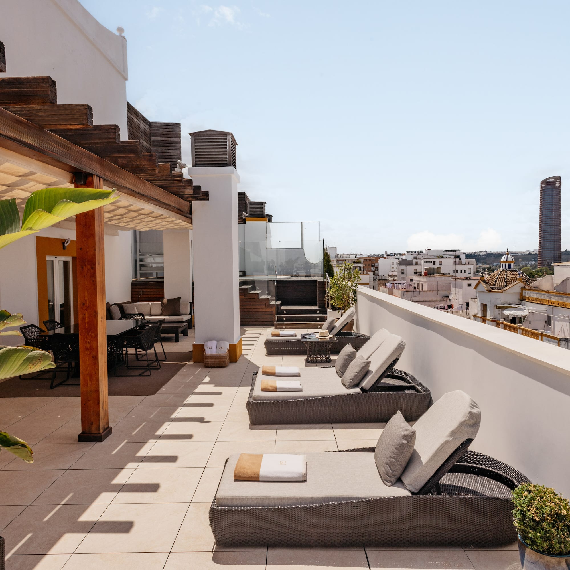 a patio with chairs and a roof top