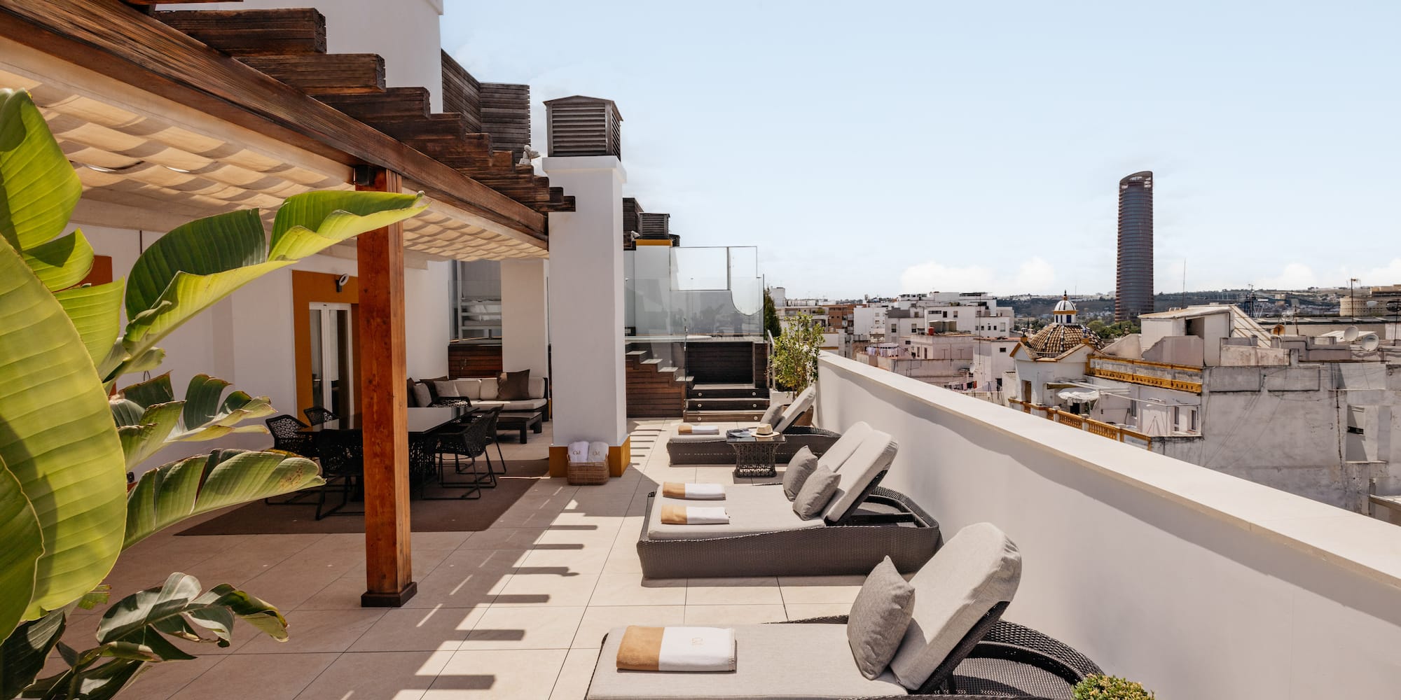 a patio with chairs and a roof top