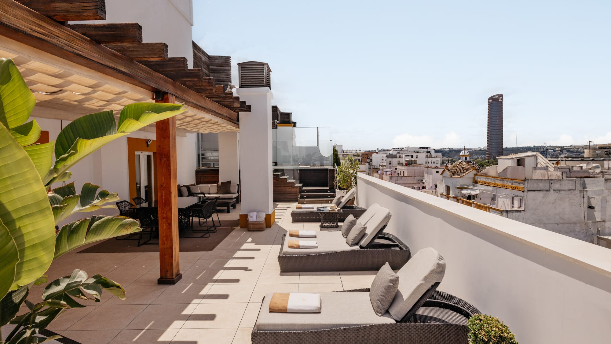 a patio with chairs and a roof top