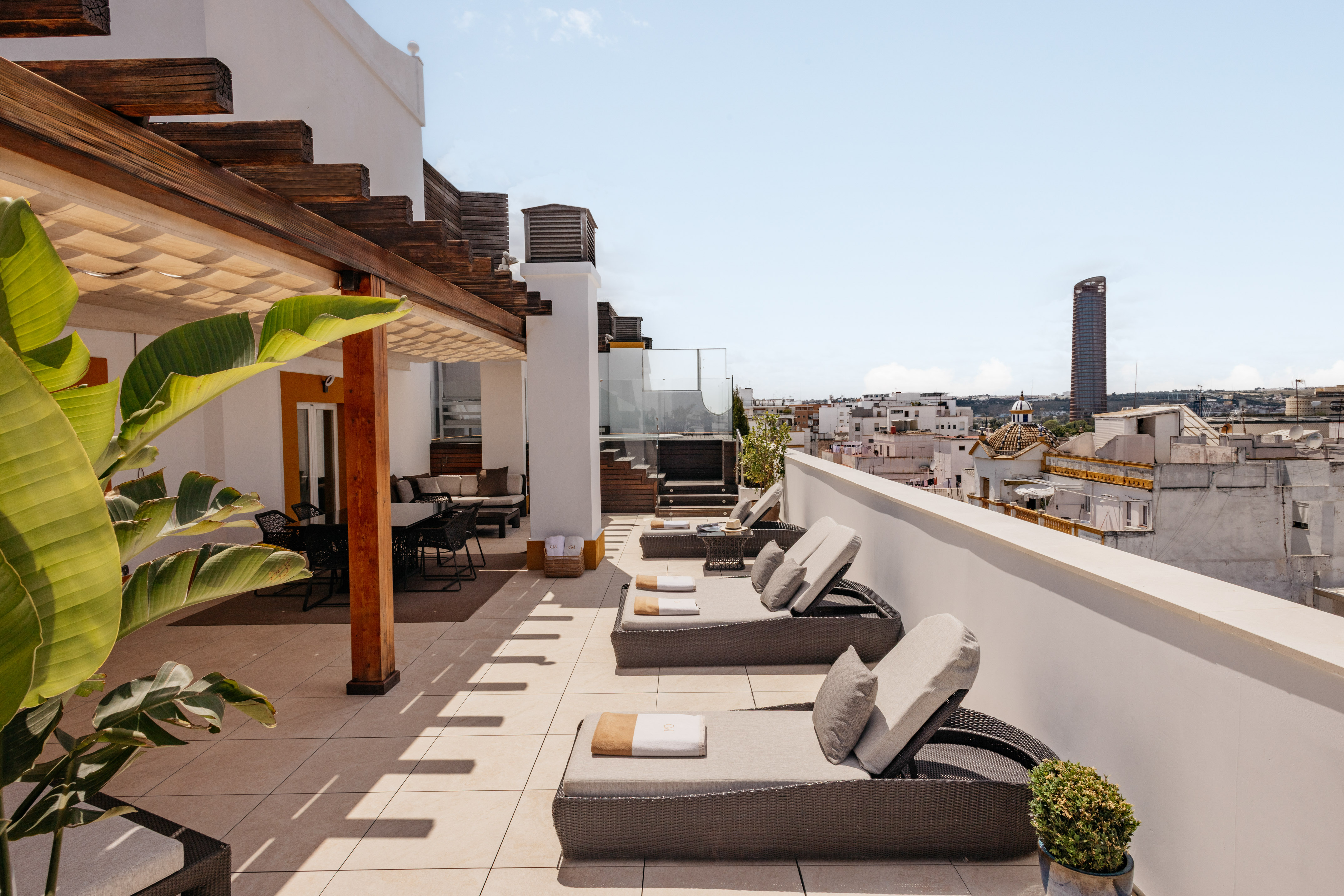 a patio with chairs and a roof top