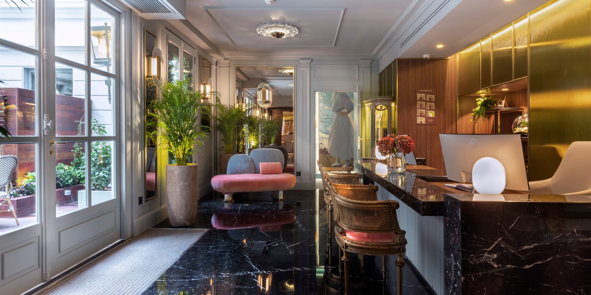 a hotel lobby with a black marble counter and chairs