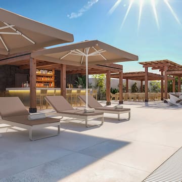 a pool with lounge chairs and umbrellas