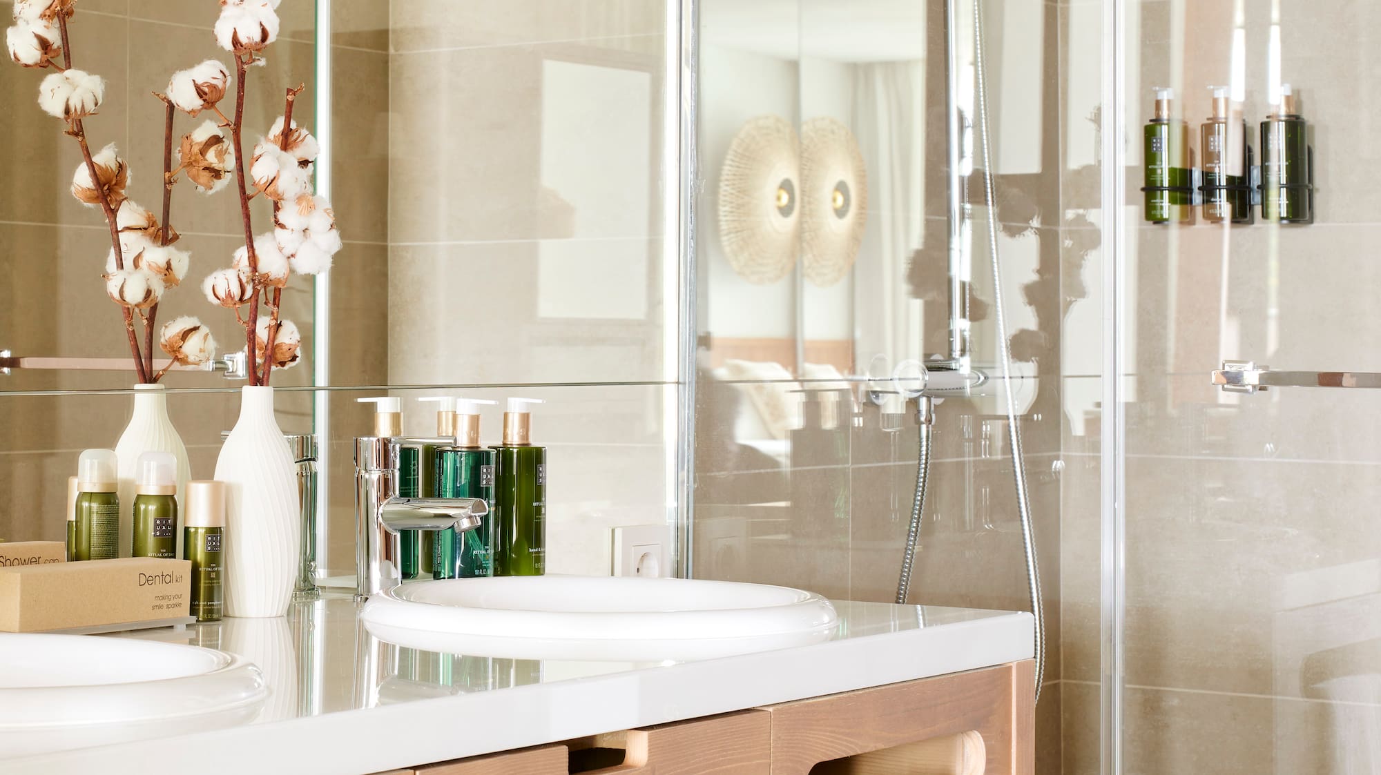 a bathroom with a glass shower and sink